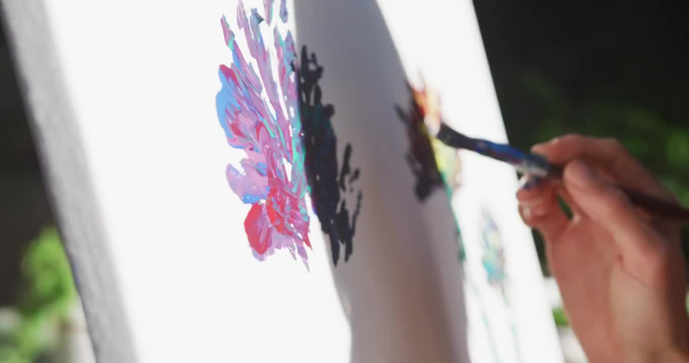 白人妇女在阳光花园绘画的中段视频素材