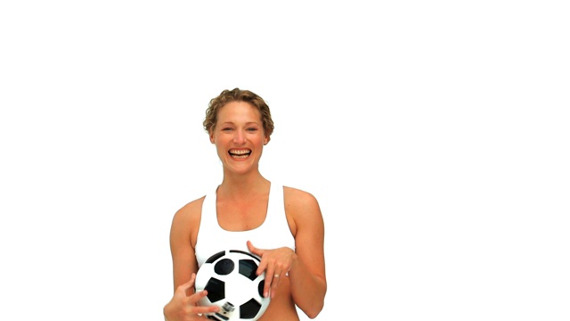 可爱的女人拿着一个足球孤立在一个白色的背景视频下载