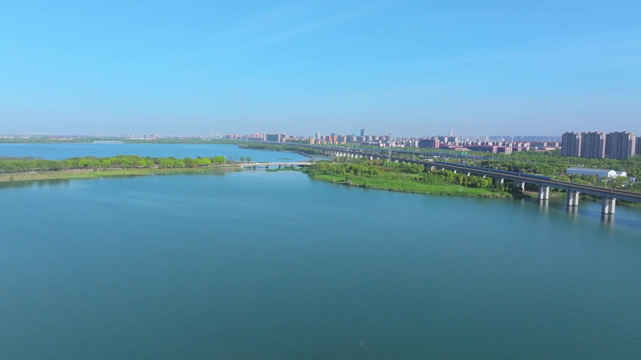 蓝天下的苏州工业园区阳澄湖京沪高铁驶过视频下载