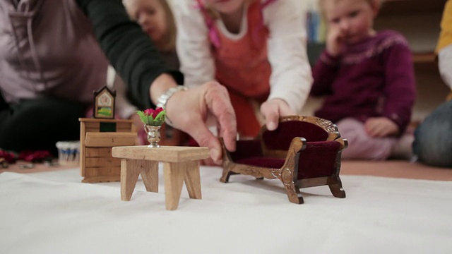 德国勃兰登堡波茨坦，中间摆着娃娃桌，女孩把五斗橱放在桌子上视频下载