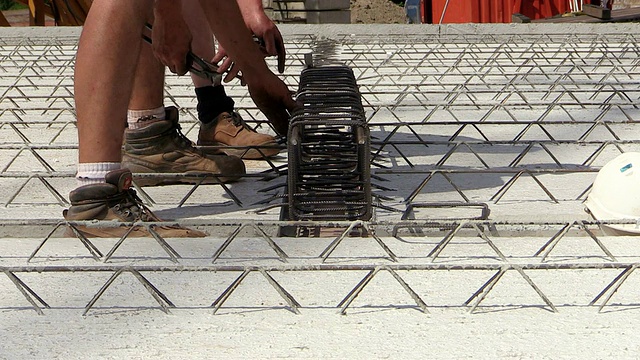 德国莱茵兰-普法尔茨的赫尔梅斯凯尔建筑工地上，工人们在建筑工地上用钢条和金属丝捆扎房屋视频素材