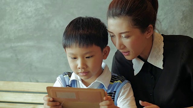亞洲母親和兒子使用平板電腦視頻素材