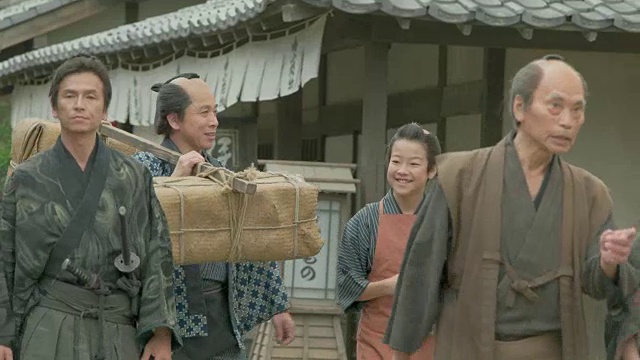 人们穿着传统的日本服装走在日本复古的小镇上。视频下载
