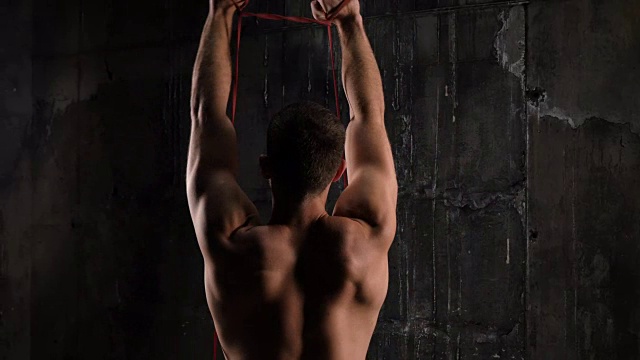 健身男模在健身房用拉筋运动的后视图视频素材