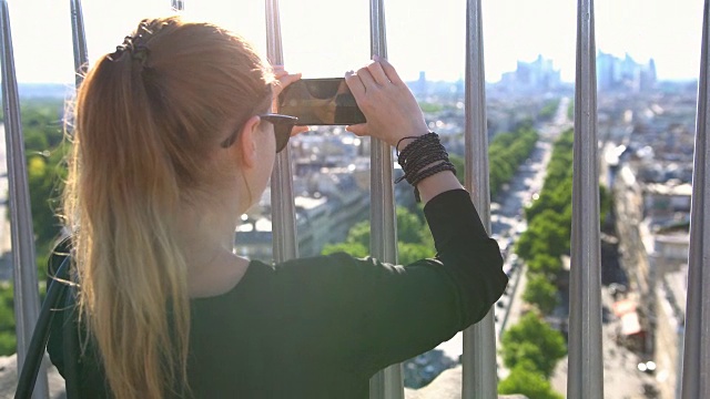 游客在凯旋门上拍摄巴黎的照片视频素材