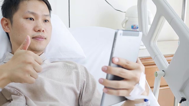 患者在床上使用数字平板电脑视频通话视频素材