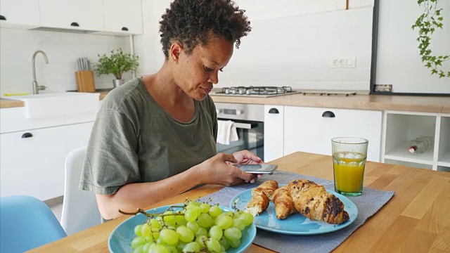 一个女人在给她的早餐拍快照。视频素材