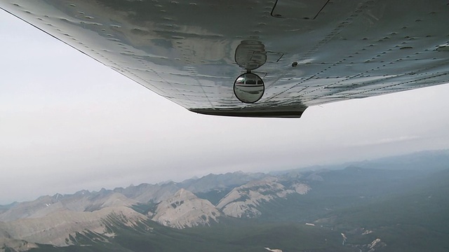 镜子和机翼的飞机飞过加拿大的落基山脉，贾斯珀国家公园，阿尔伯塔，加拿大视频素材