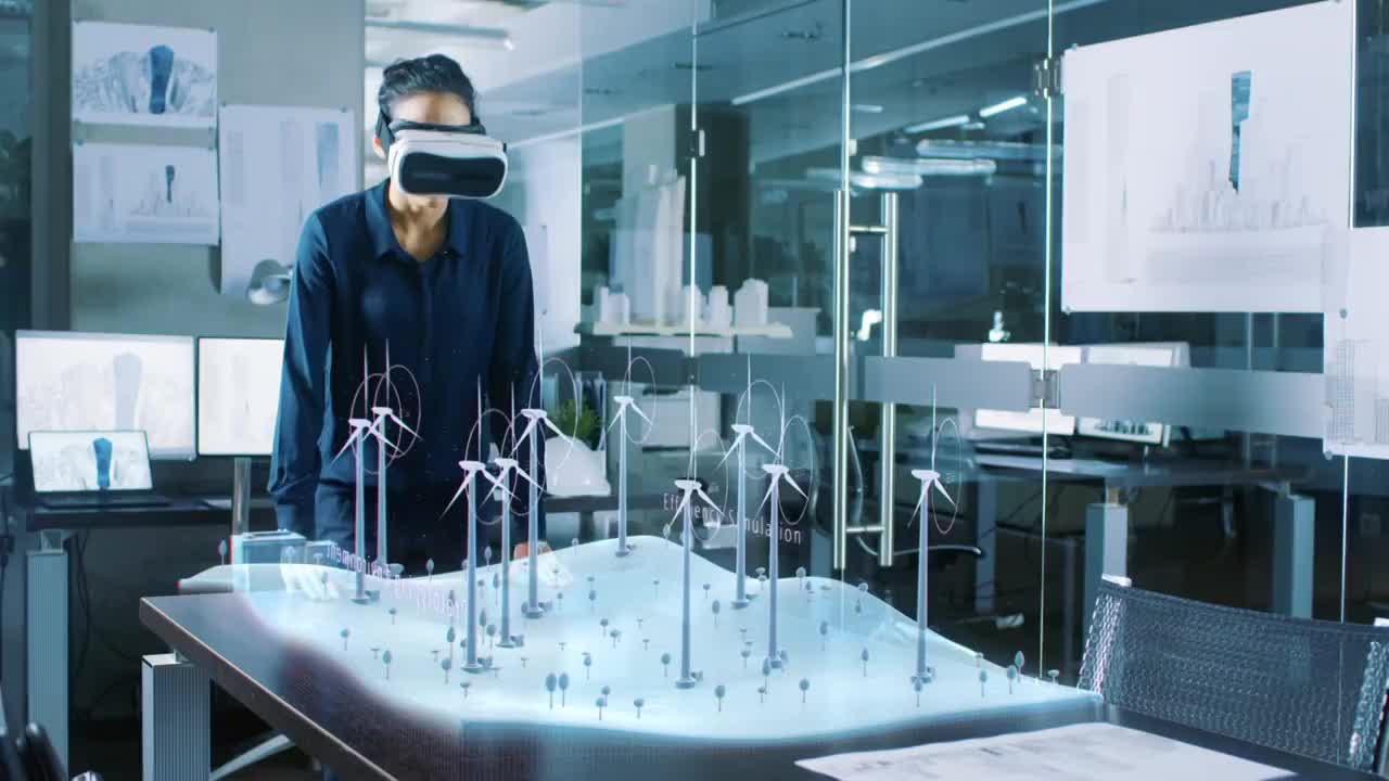 戴着虚拟现实眼镜的未来主义女性工程师，用风力涡轮机设计3D领域。可再生能源专家进行技术效率测试。视频购买