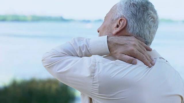 成熟男人按摩颈肩，衰老健康问题，受伤疼痛视频素材