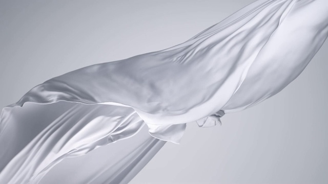白色丝质织物随风飘动，灰色背景，慢镜头视频素材