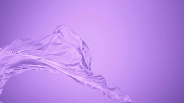紫色的丝质织物在紫色的背景下随风飘动，慢镜头视频素材