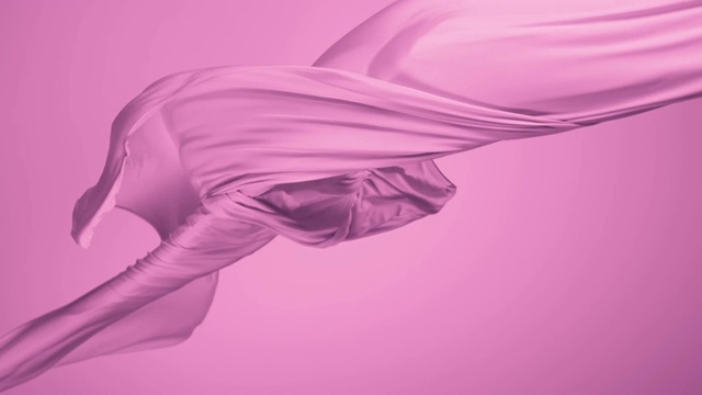 粉红色丝质织物随风流动在粉红色的背景，慢镜头视频素材