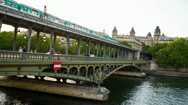 横跨河上的桥梁，有两层交通——机动车和行人，上面有铁路高架桥视频素材
