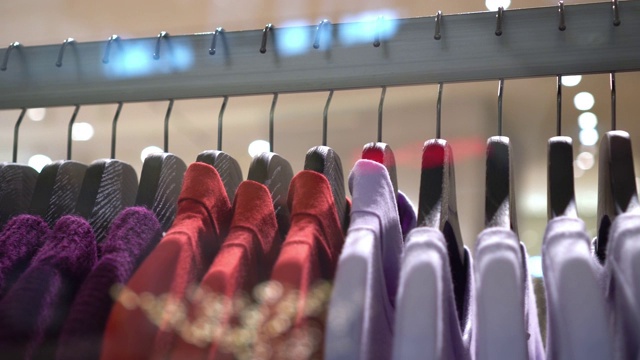 在百货公司，购物中心和服装概念的时尚服装店挂衣架和衣架上的扶手4k镜头的场景视频素材