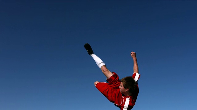 足球运动员在半空中踢球，慢动作视频素材