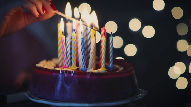 年轻女孩在生日蛋糕上点燃16支蜡烛视频下载
