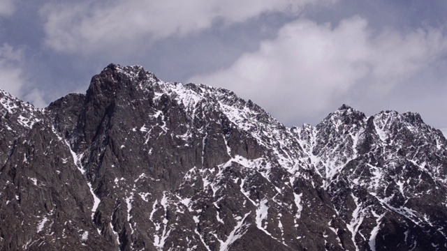 以雪为背景的高高的岩石山仍然是浮云。高加索地区。格鲁吉亚。视频下载