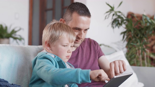 父亲和儿子一起看平板电脑屏幕视频下载