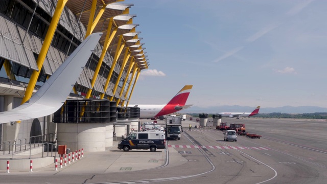 4k全景马德里-巴拉哈斯阿道夫Suárez机场卫星终端在西班牙马德里。飞机在终点站等待登机。视频素材