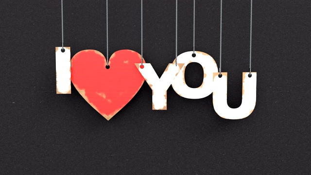 美丽的3D动画的文字“我爱你”在一个黑色的背景视频素材