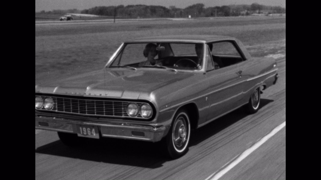 1964年的今天，一男一女在高速公路上开着一辆雪佛兰汽车视频下载