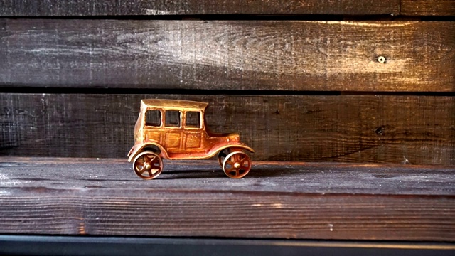 木制背景上的老式汽车雕像。极简主义。视频下载