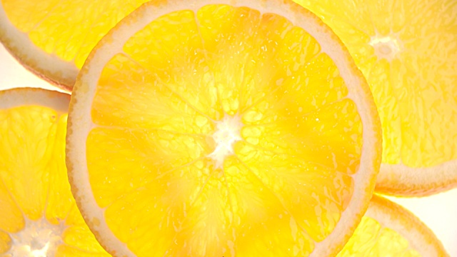 近距离切片橙色在白色的背景。新鲜健康的水果。视频购买