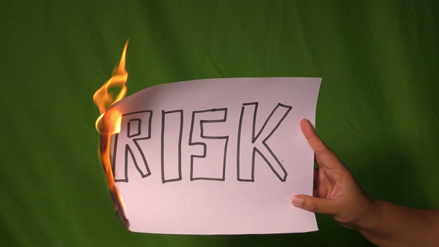 一只手拿着燃烧着的纸，上面写着危险的文字。视频下载