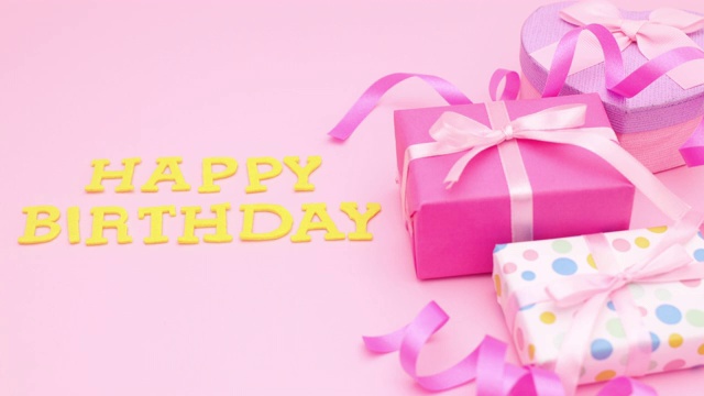 生日快乐的标题出现在粉红色的主题与礼物。停止运动视频下载