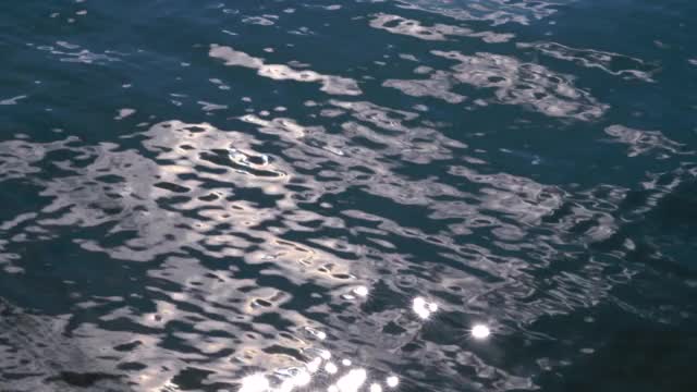 碧蓝的水面荡漾着涟漪，阳光普照湖面视频素材