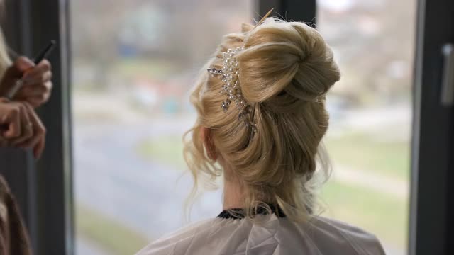 年轻的新娘与美丽的发型准备与visagist的帮助视频下载