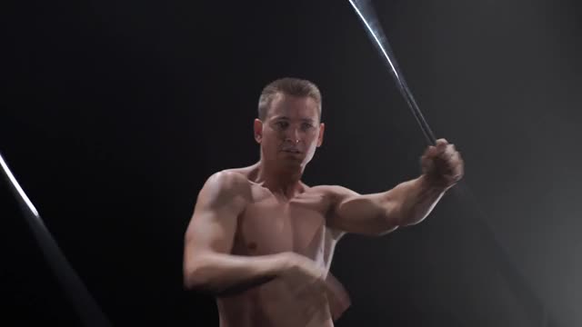 马戏团男性肌肉表演者在黑色背景下用戏法戏法的立方体道具。集中，控制，力量和力量的概念视频下载