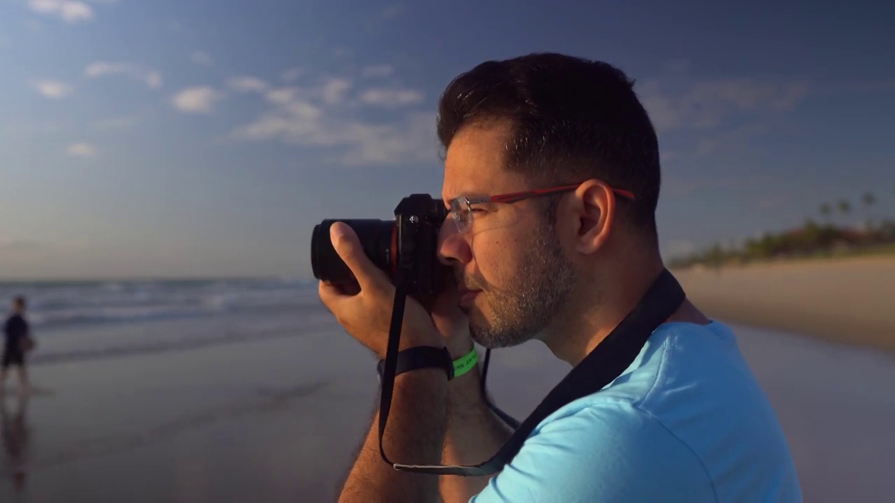 日出时分，一名男子在加林哈斯港海滩上拍照视频下载
