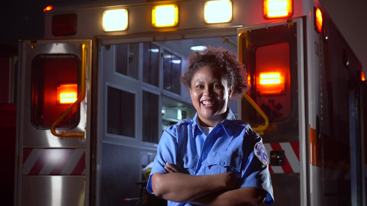 女护理人员站在救护车前面视频下载