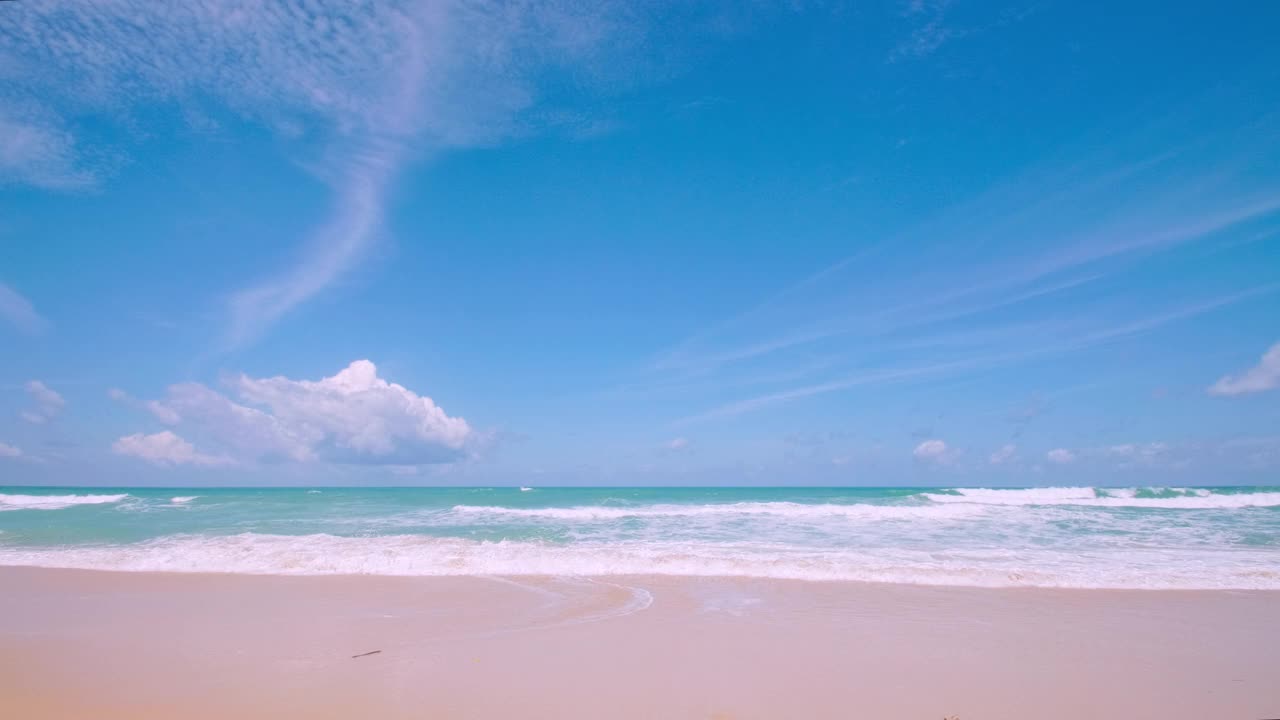 4K美丽的热带海滩，蓝天白云。热带海滩与海浪冲击空海滩。安达曼普吉岛海滩泰国。沙滩和天空在美丽的夏日假期自由视频素材