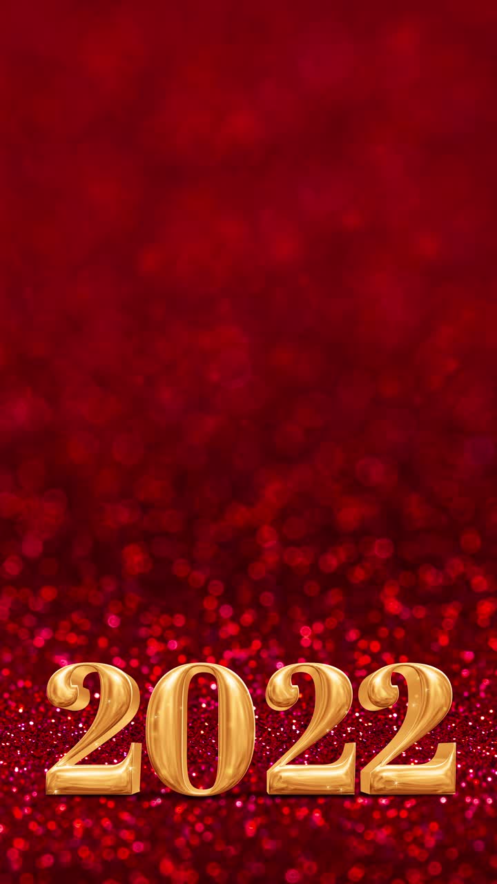 竖版《新年快乐2022》金色镶在闪闪生辉的红色镶景墙上，节日庆祝理念。中国新年庆祝16:9比例视频下载
