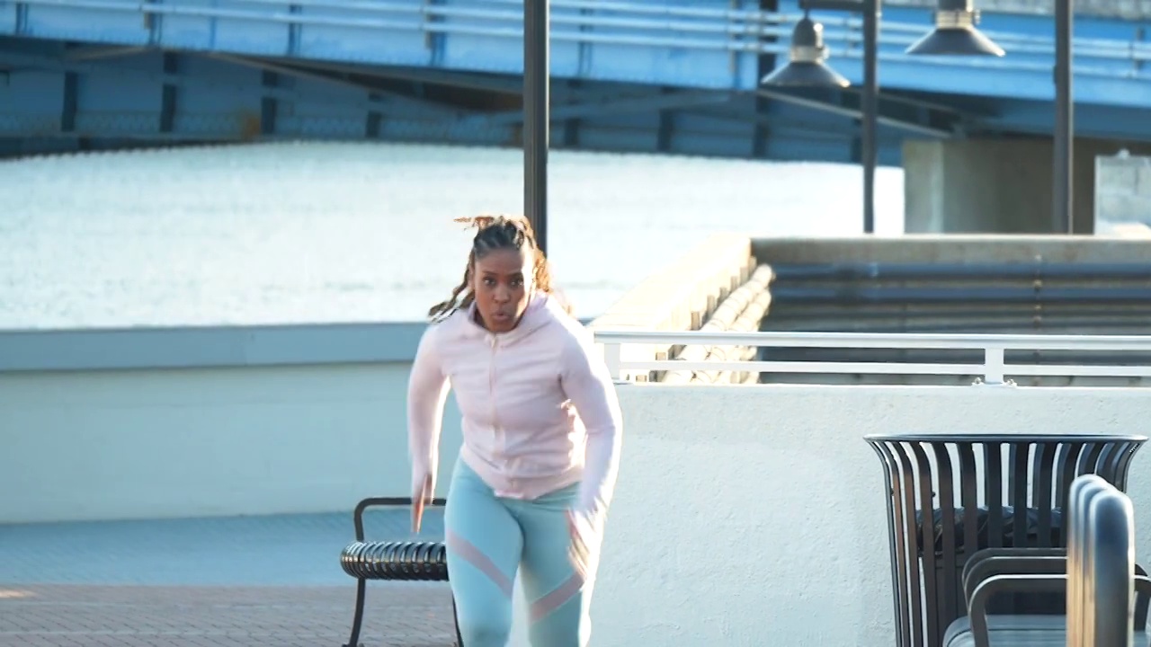 一个非裔美国女人在城市海滨冲刺视频素材