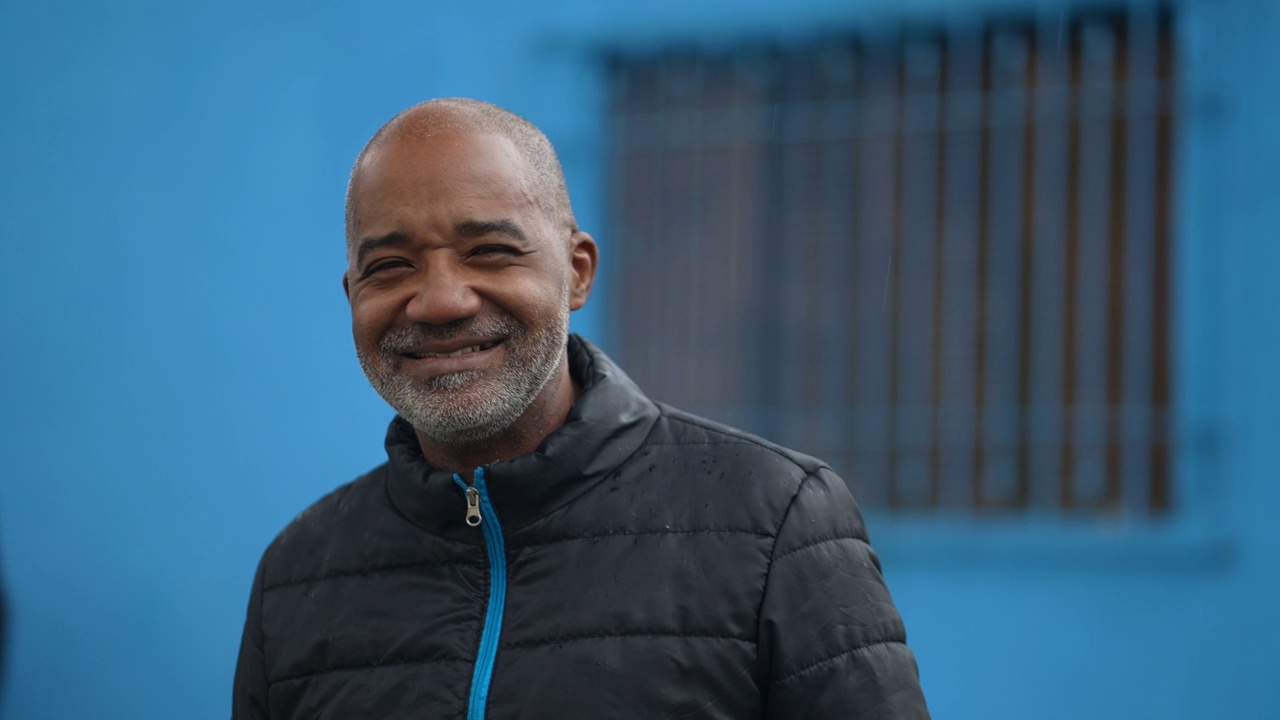 一个快乐的黑人老人站在街上对着镜头微笑视频下载