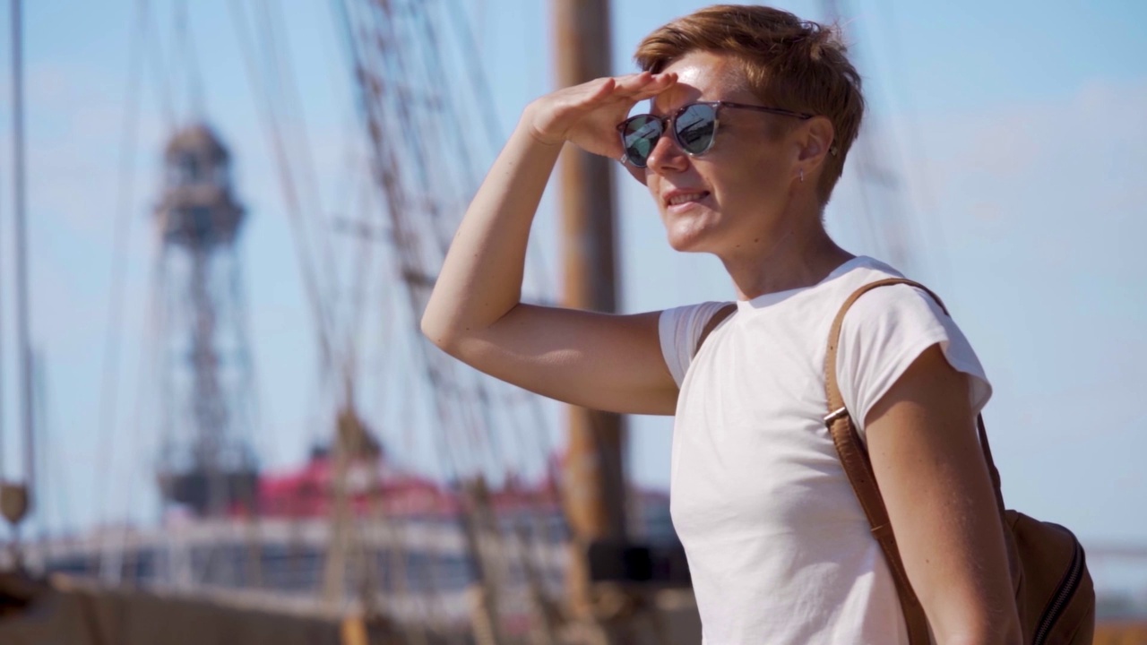 快乐的旅游女孩在一个港口旅行在巴塞罗那，西班牙。度假观光概念通过探索有趣的地方，在地中海租船或游艇旅行视频素材
