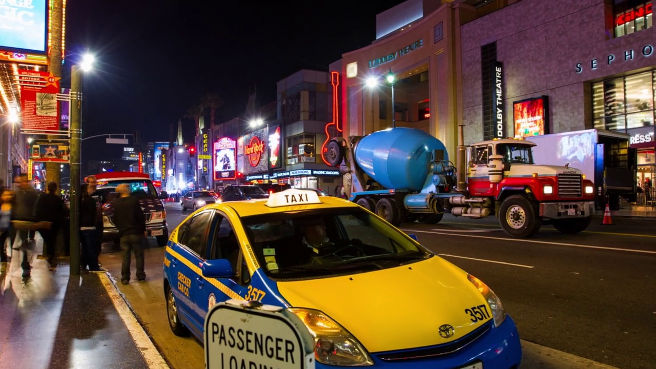 行人走在街道上，出租车停在路边，照明城市-洛杉矶，加利福尼亚州视频下载