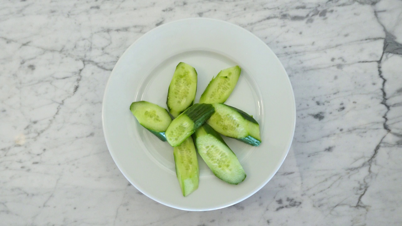 开胃美味的黄瓜沙拉在白色旋转盘。视频下载
