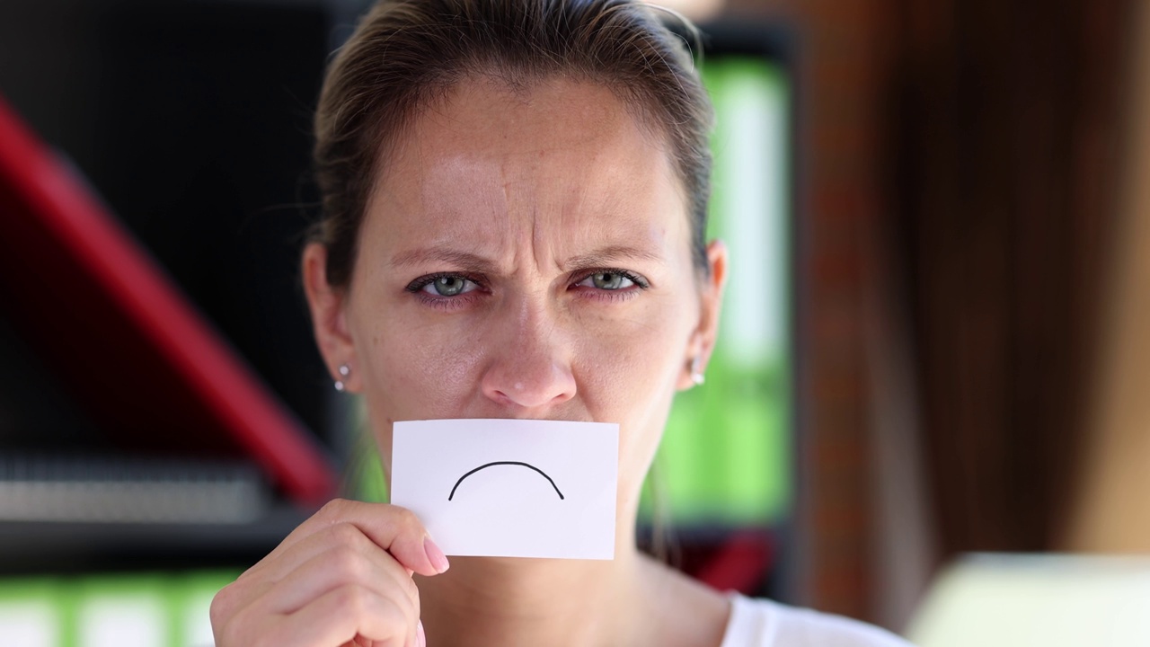 疲惫的女人把她的脸一张纸画悲伤的微笑4k电影慢动作视频下载