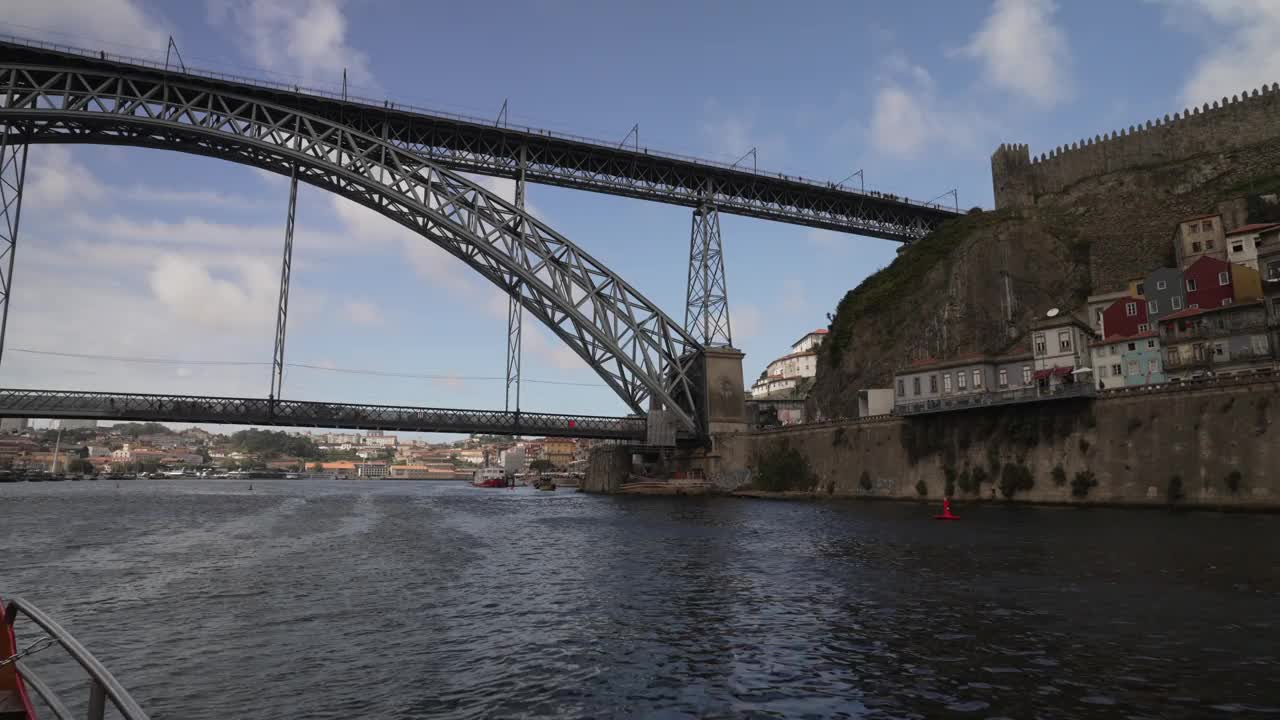 在欧洲葡萄牙北波尔图的杜罗河上，乘船游览联合国教科文组织世界遗产Dom Luis I桥视频素材
