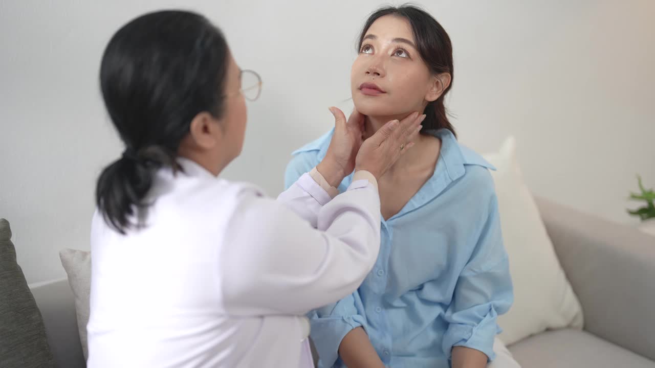 亚洲医生检查美丽病人的喉咙，检查症状、保健和医疗观念。视频下载