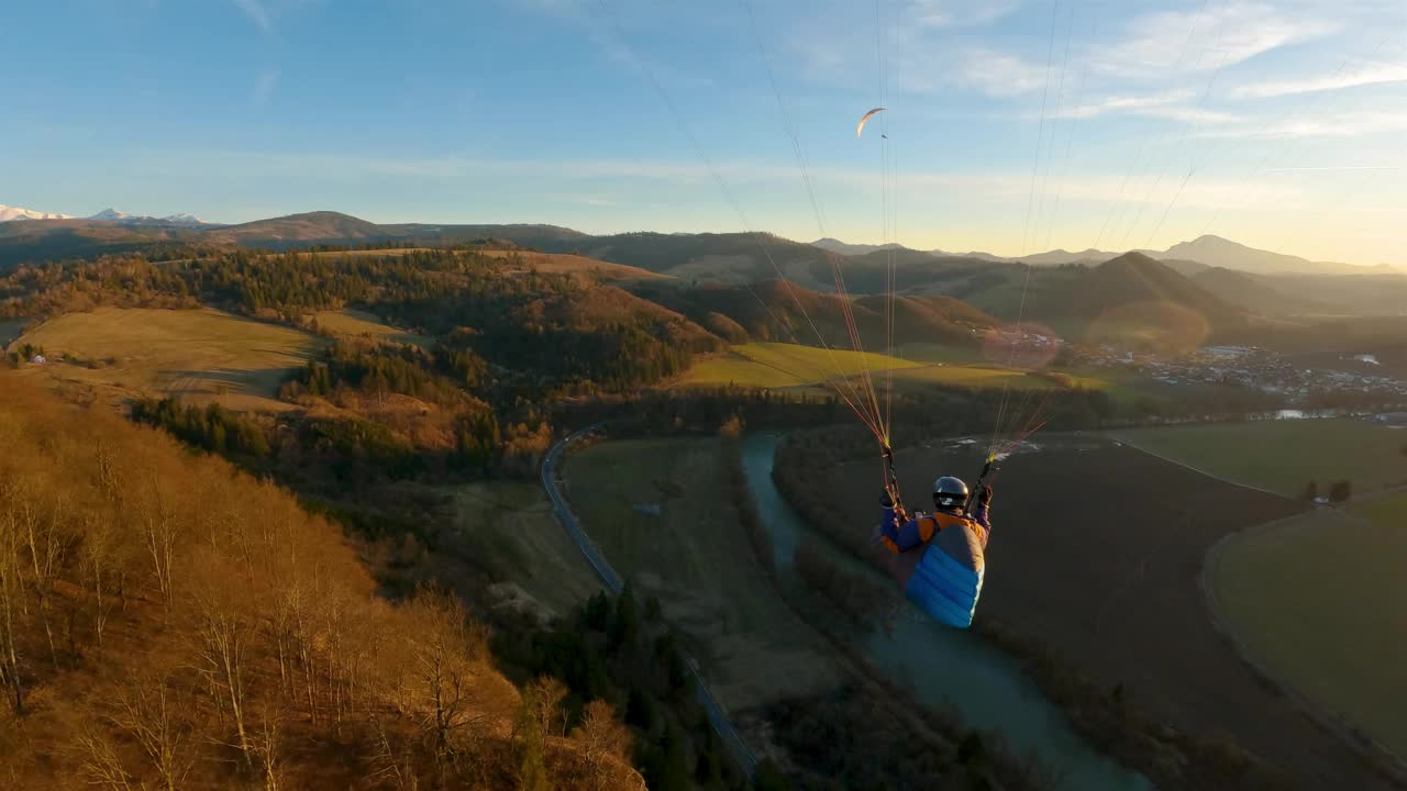 飞翔在春天的大自然之上，滑翔伞肾上腺素冒险自由跟随动作相机视频下载