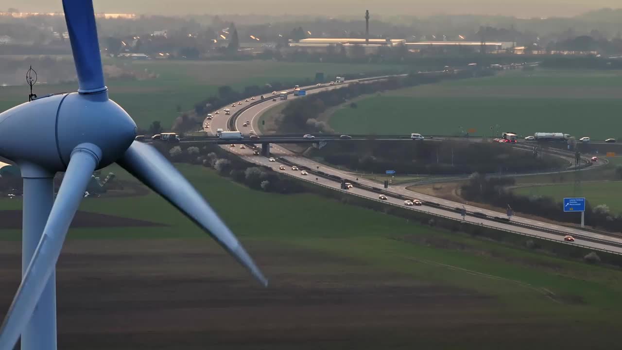 风力涡轮机的超远摄镜头。贡多拉的特写。高速公路上的汽车。图中风力涡轮机与高速公路的连接。视频下载