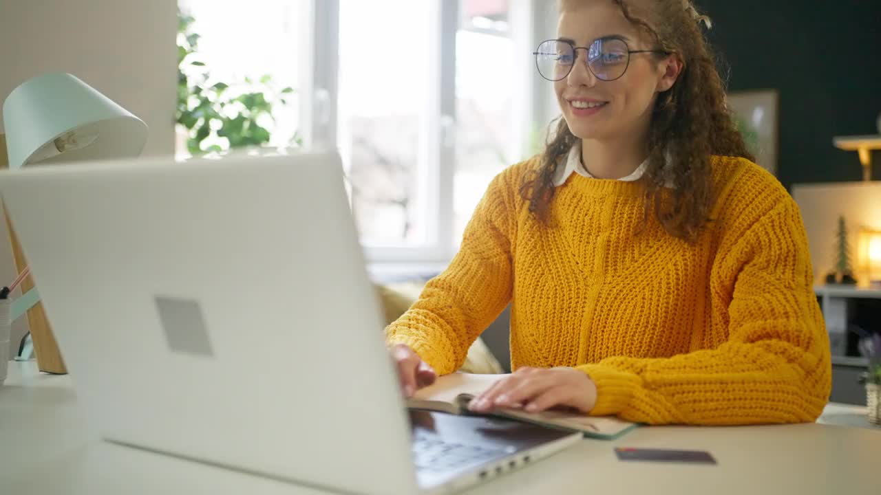 现代年轻白人女性用信用卡在笔记本电脑上网购视频素材