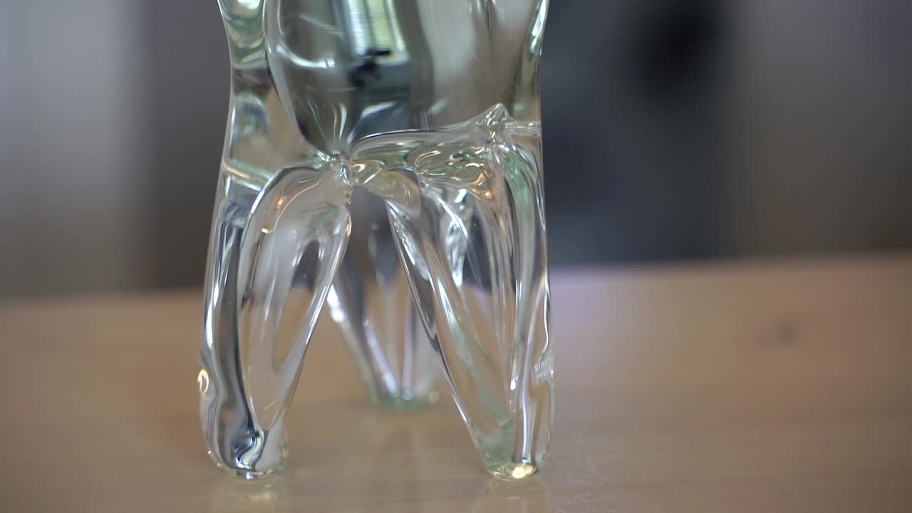 一颗牙齿的玻璃雕像。牙科诊所的牙齿模型。视频下载