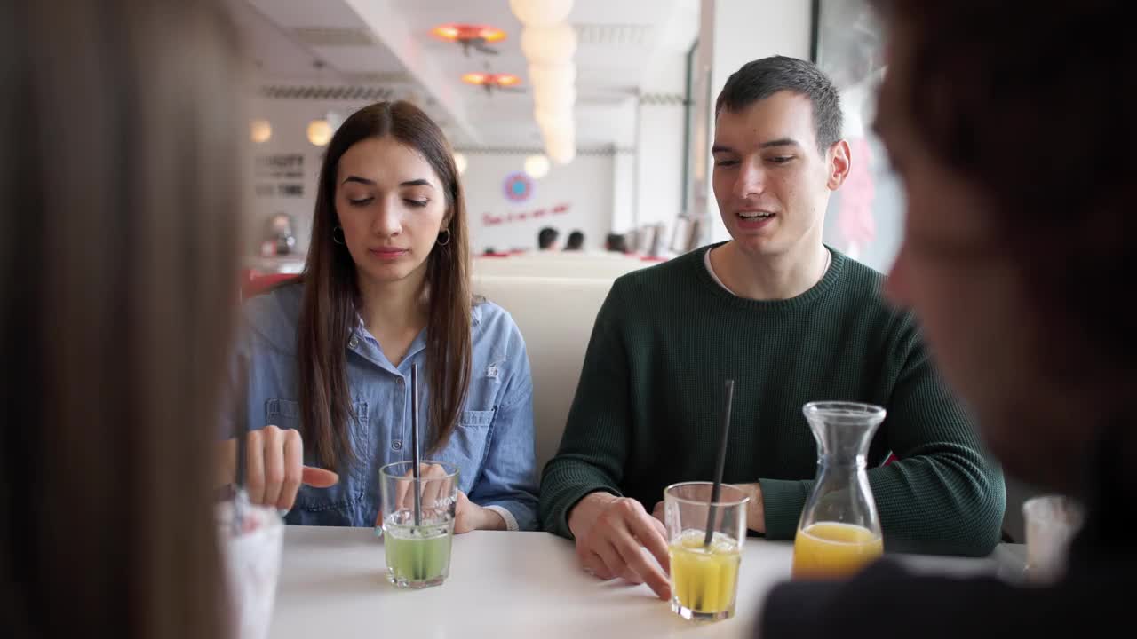 四人约会的年轻白种人在复古快餐店喝酒视频下载